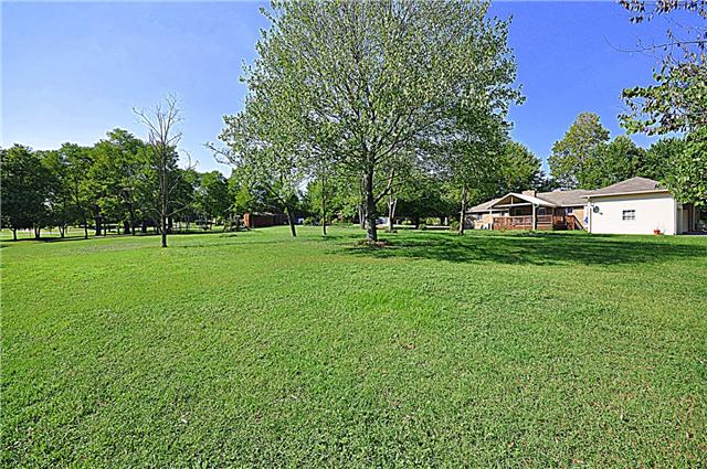 4019 Arno Road Franklin, TN 37064 - Photo 11 of 12 a view of a park with large trees and a wooden fence