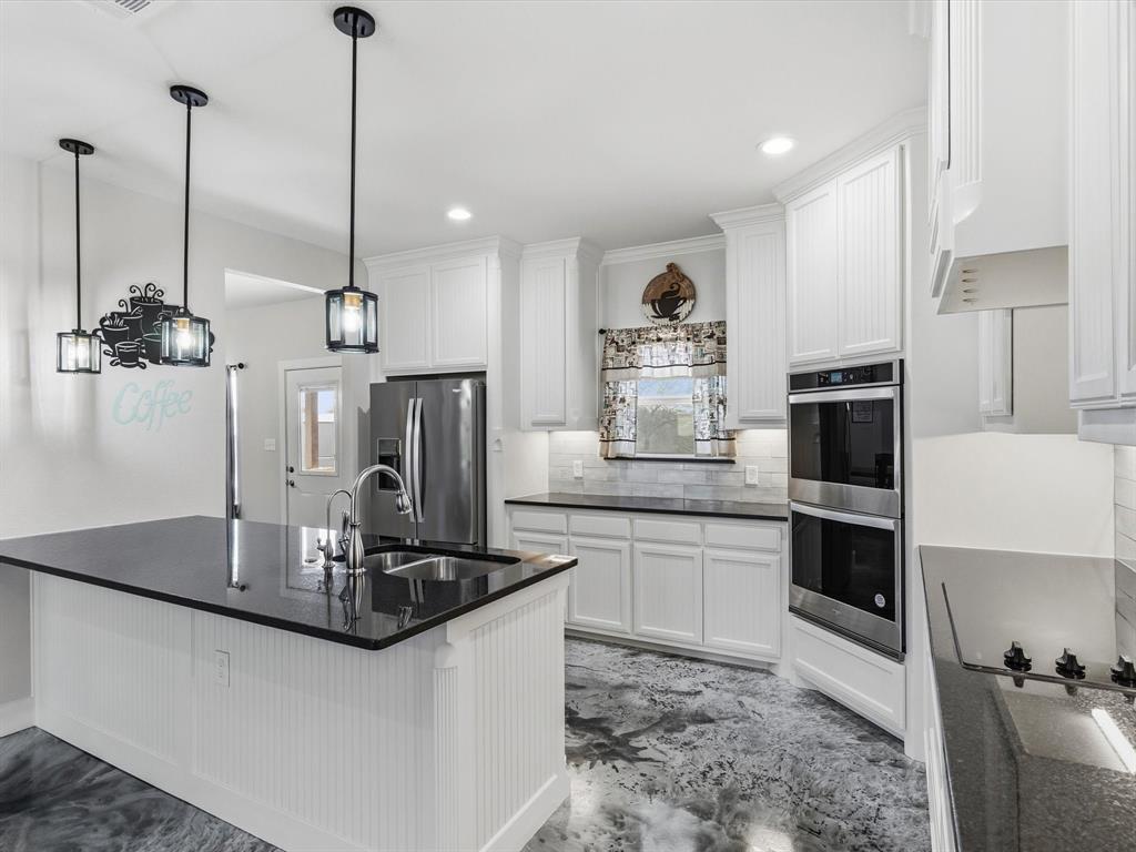 123 Kriston Lane Springtown, TX 76082 - Photo 11 of 39 a kitchen with stainless steel appliances granite countertop a sink a stove and a refrigerator