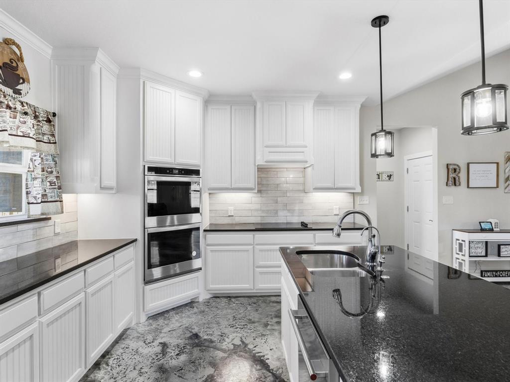 123 Kriston Lane Springtown, TX 76082 - Photo 13 of 39 a kitchen with a sink a stove and chairs