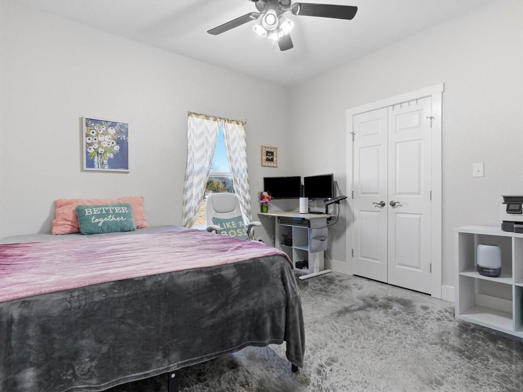 123 Kriston Lane Springtown, TX 76082 - Photo 14 of 39 a bedroom with a bed and a television