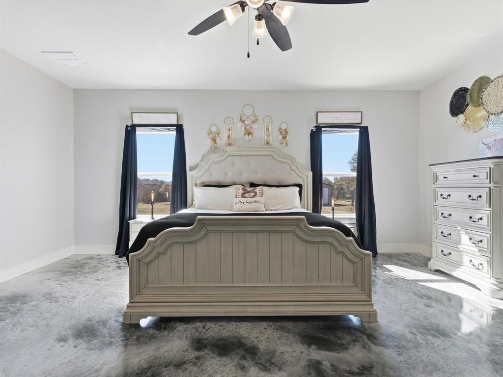 123 Kriston Lane Springtown, TX 76082 - Photo 22 of 39 a bedroom with a bed and painting on the wall