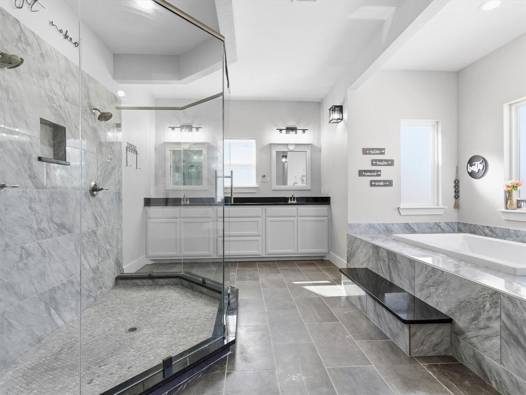 123 Kriston Lane Springtown, TX 76082 - Photo 23 of 39 a large bathroom with a granite countertop double vanity sink a mirror and a bathtub