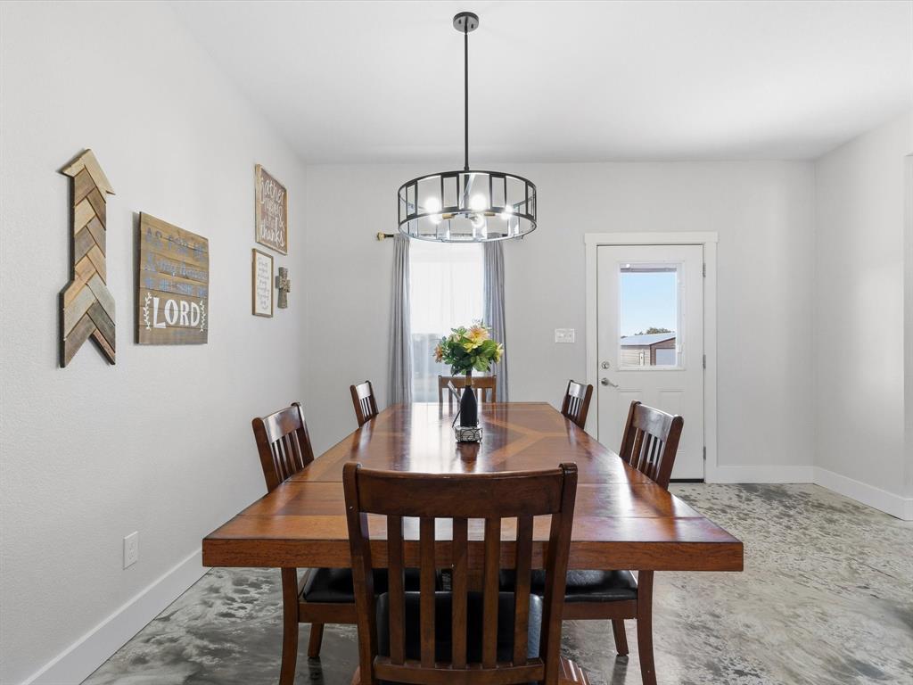 123 Kriston Lane Springtown, TX 76082 - Photo 9 of 39 a view of a dining room with furniture window and wooden floor