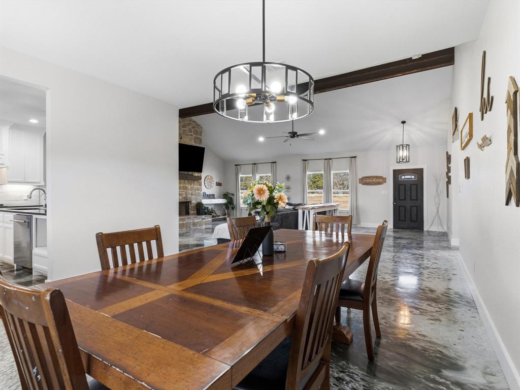 123 Kriston Lane Springtown, TX 76082 - Photo 10 of 39 a dining room with furniture a chandelier and wooden floor