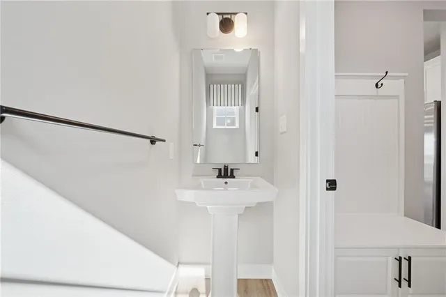 a bathroom with a sink a mirror and shower