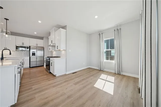 a view of kitchen with cabinets and wooden floor