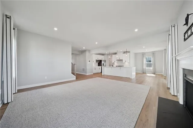 a big room with closet and a fireplace