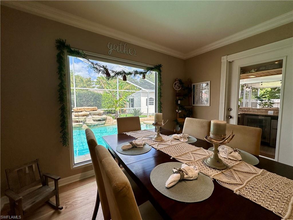 17444 Ingram Road Fort Myers, FL 33967 - Photo 9 of 27 Dining room featuring crown molding and light hardwood / wood-style flooring