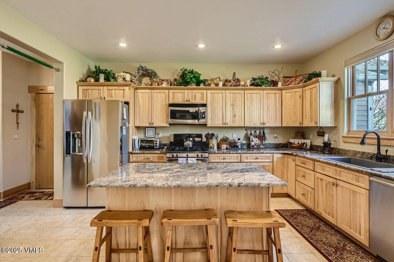 1987 Eagle Ranch Road Eagle, CO 81631 - Photo 12 of 37 a kitchen with stainless steel appliances granite countertop a refrigerator and a stove top oven