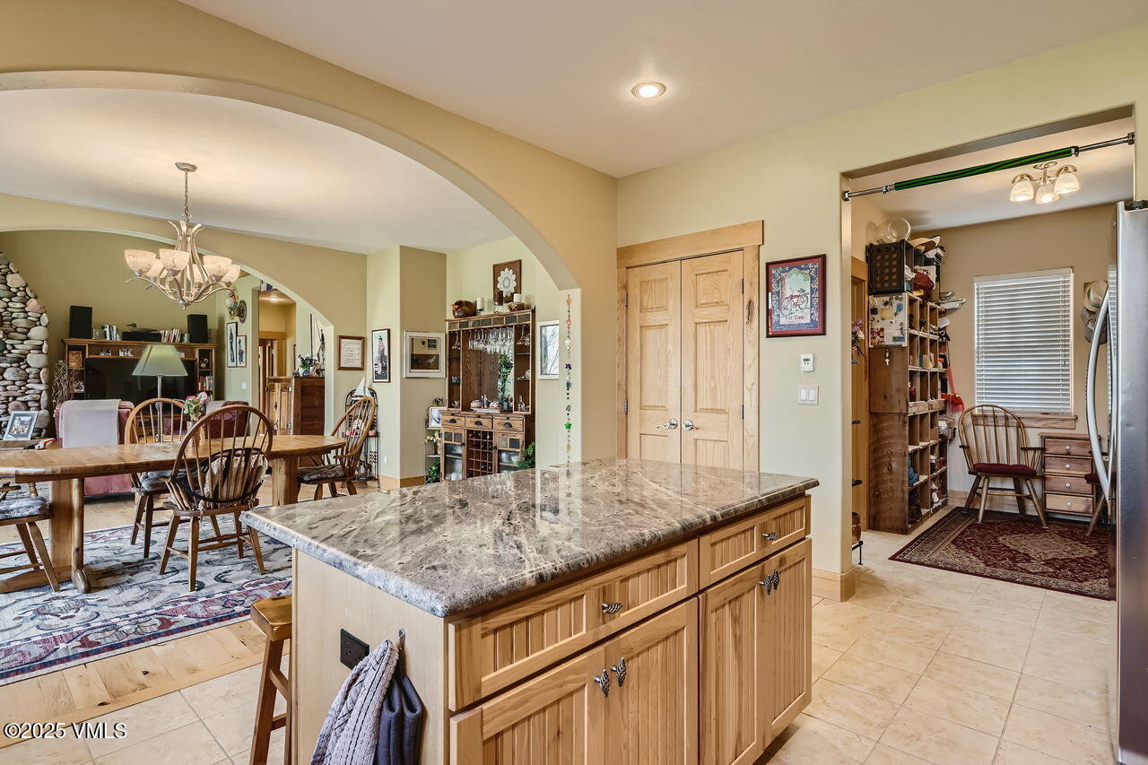 1987 Eagle Ranch Road Eagle, CO 81631 - Photo 15 of 37 a kitchen island with granite countertop a table and chairs in it