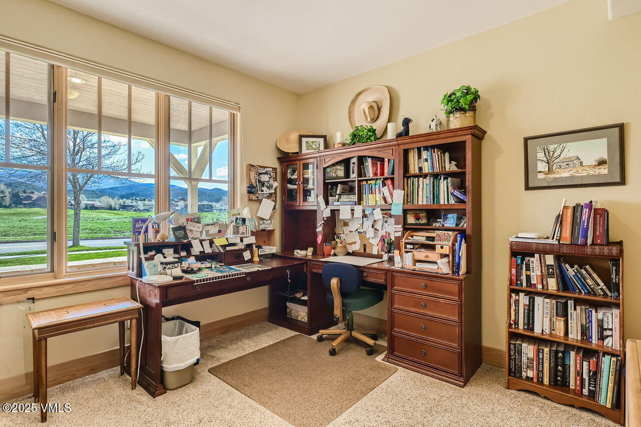 1987 Eagle Ranch Road Eagle, CO 81631 - Photo 17 of 37 a view of a workspace with a bookshelf and a window