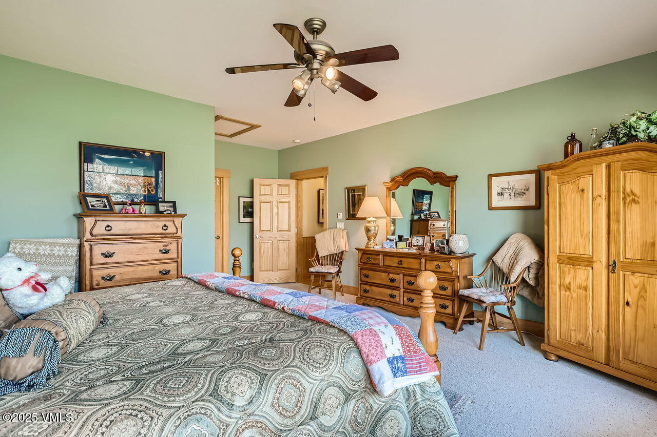 1987 Eagle Ranch Road Eagle, CO 81631 - Photo 19 of 37 a bedroom with a bed and wooden floor