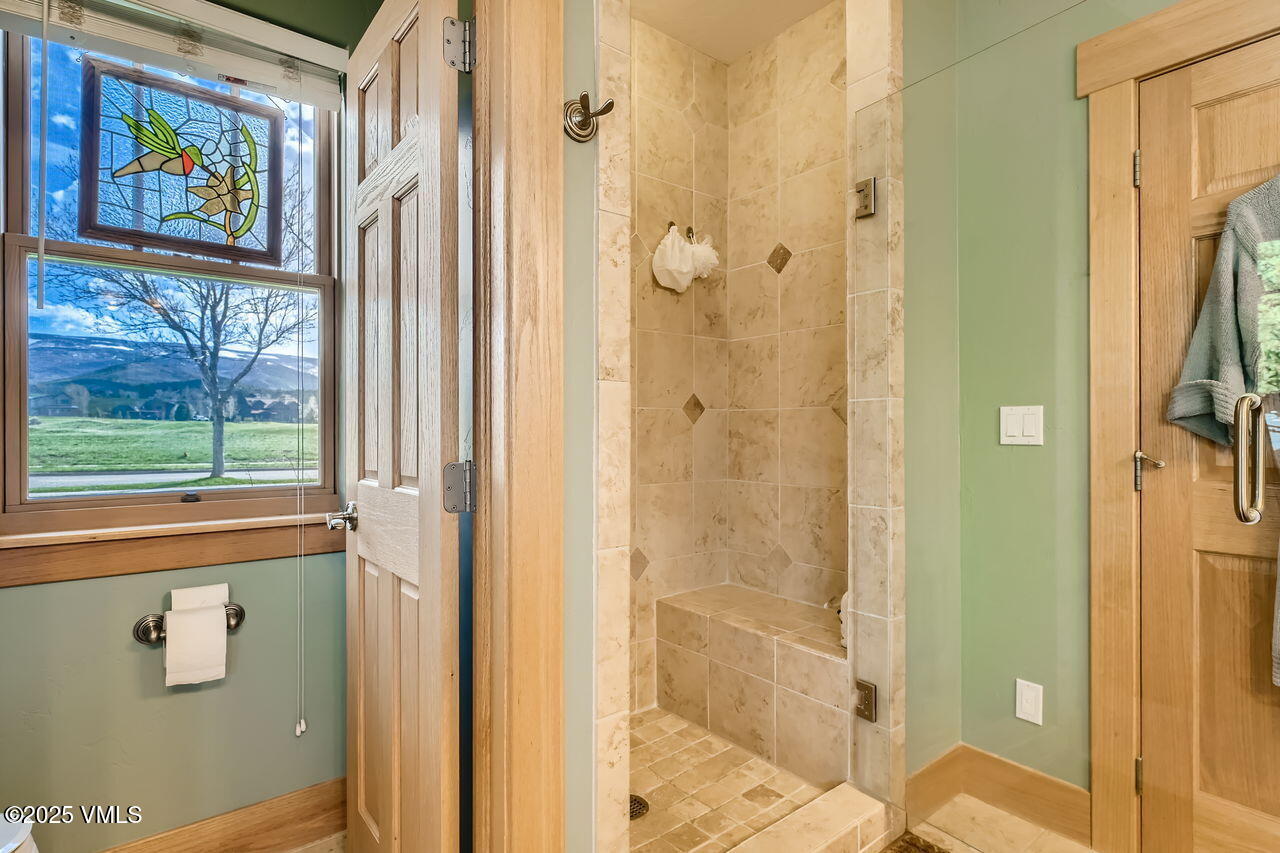 1987 Eagle Ranch Road Eagle, CO 81631 - Photo 20 of 37 a bathroom with a glass shower door