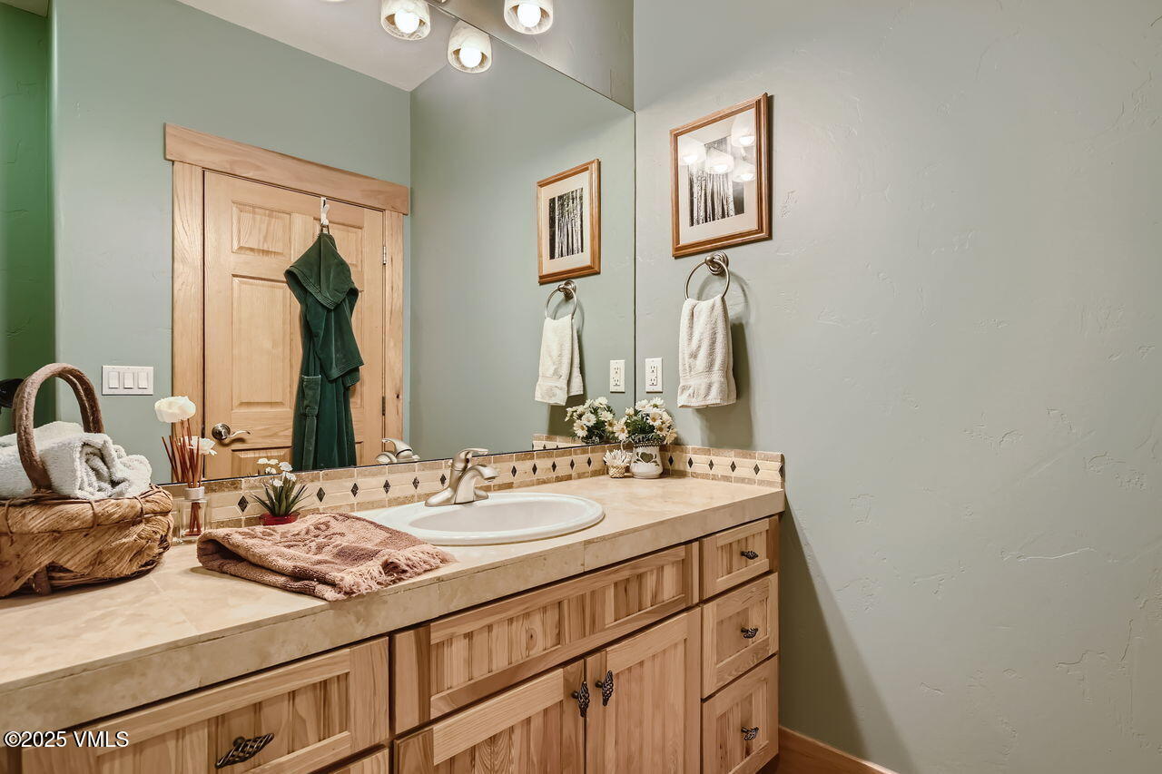 1987 Eagle Ranch Road Eagle, CO 81631 - Photo 23 of 37 a bathroom with a sink and a mirror