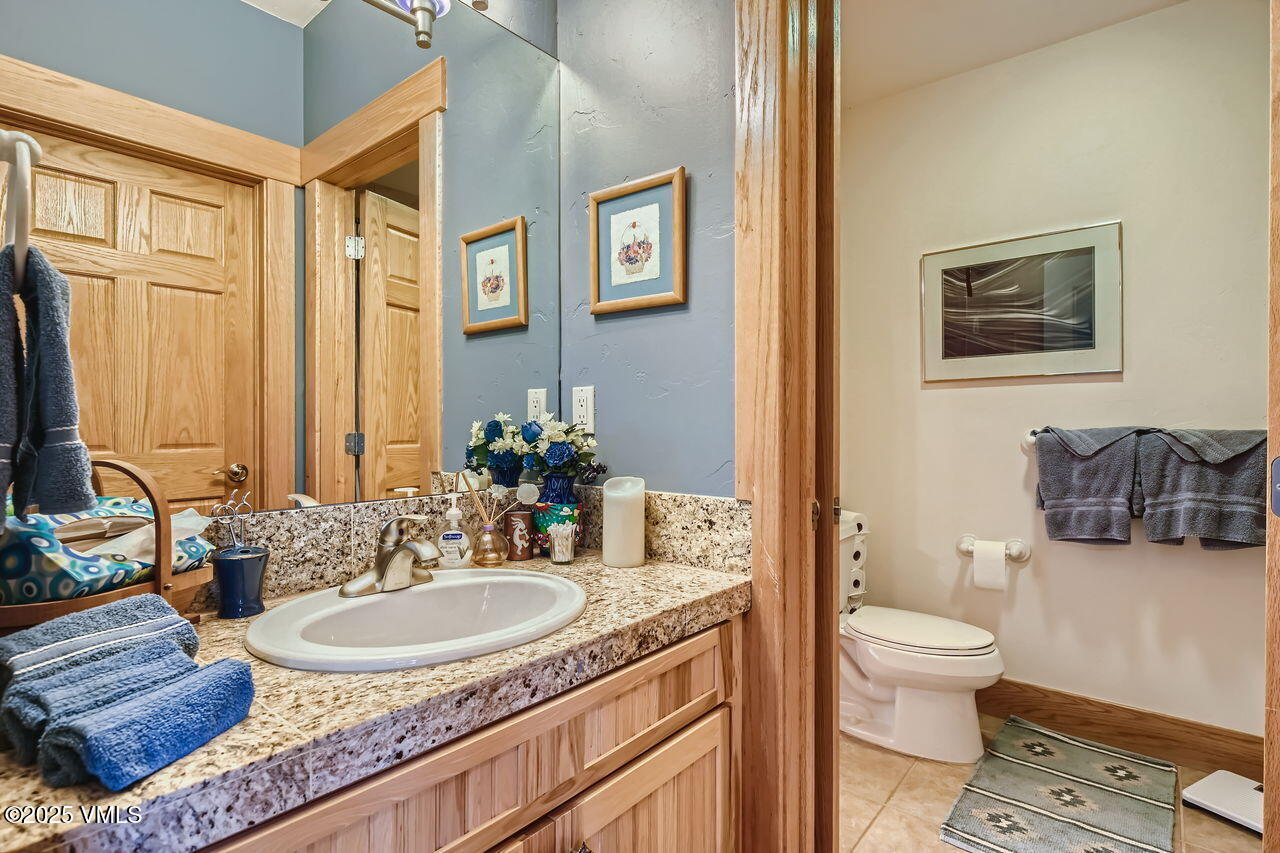 1987 Eagle Ranch Road Eagle, CO 81631 - Photo 27 of 37 a bathroom with a granite countertop sink and a mirror