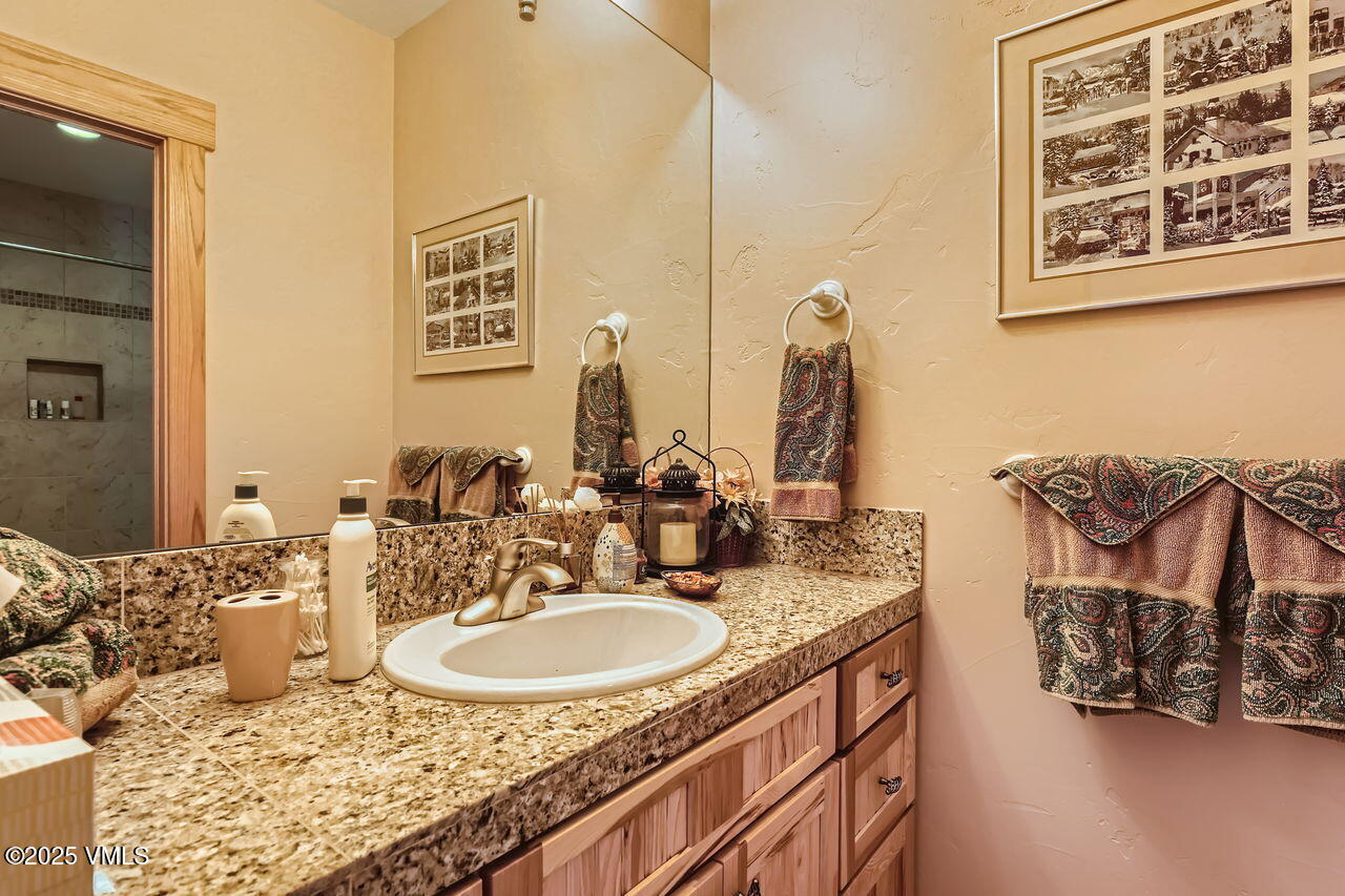 1987 Eagle Ranch Road Eagle, CO 81631 - Photo 28 of 37 a bathroom with a granite countertop sink and a mirror