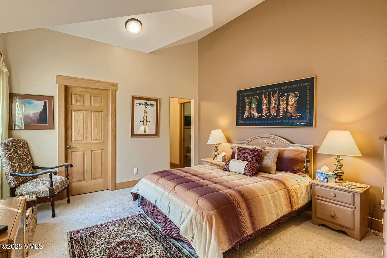 1987 Eagle Ranch Road Eagle, CO 81631 - Photo 29 of 37 a bedroom with a bed a rug and chair