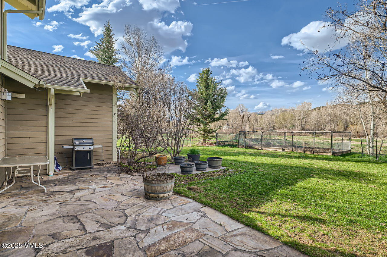 1987 Eagle Ranch Road Eagle, CO 81631 - Photo 34 of 37 a view of a chair and table in backyard of the house