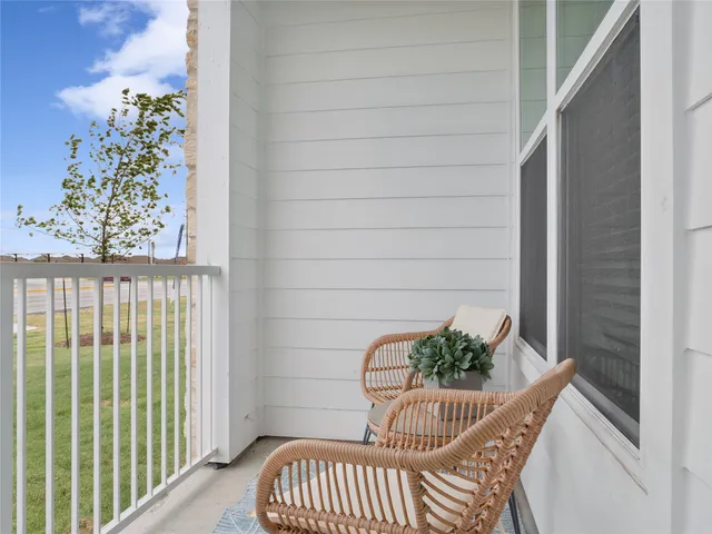 a view of a balcony with furniture