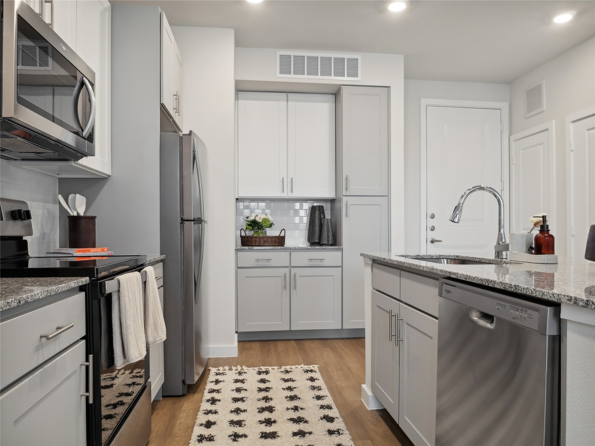 23100 Clay Road, Unit C 1114 Katy, TX 77493 - Photo 2 of 13 a kitchen with a sink stove and refrigerator