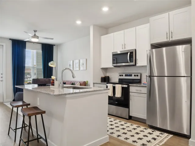 a kitchen with stainless steel appliances a refrigerator stove and sink