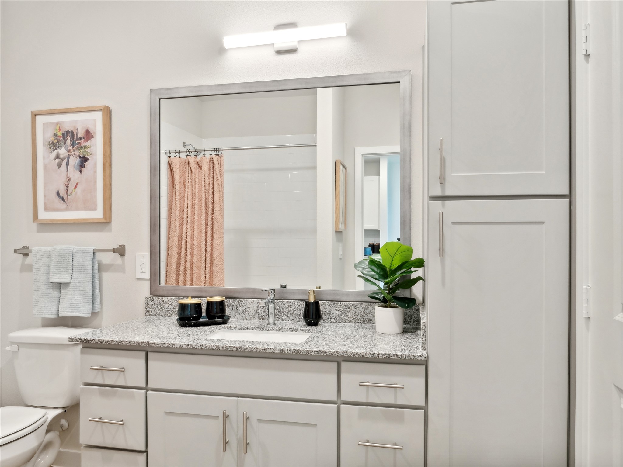 23100 Clay Road, Unit C 1114 Katy, TX 77493 - Photo 9 of 13 a bathroom with a granite countertop sink a mirror and a potted plant