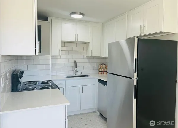 a kitchen with a refrigerator and a sink