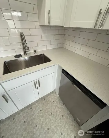 a kitchen with a sink and cabinets