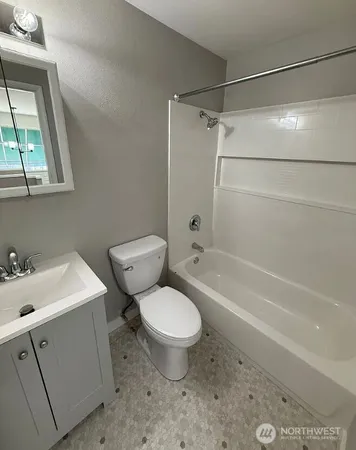 a bathroom with a toilet sink and shower