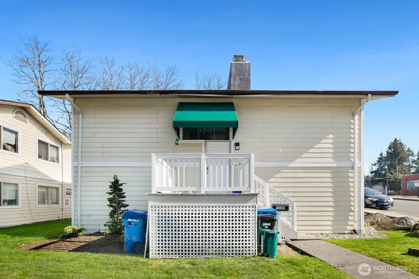 a front view of a house with a garden and plants