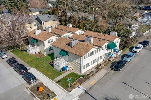 an aerial view of multiple houses with yard