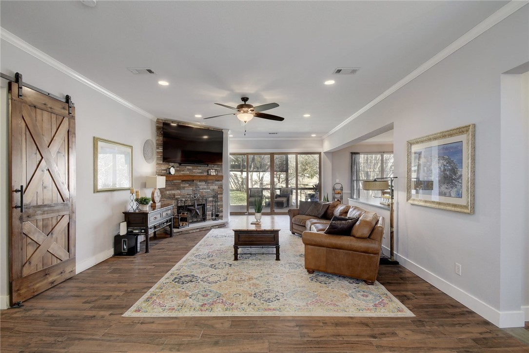 2220 Rimrock Drive Austin, TX 78738 - Photo 1 of 1 Welcome home! Wide open from front to back, this living space has gorgeous sliding doors and is open to the kitchen as well as the covered back patio.