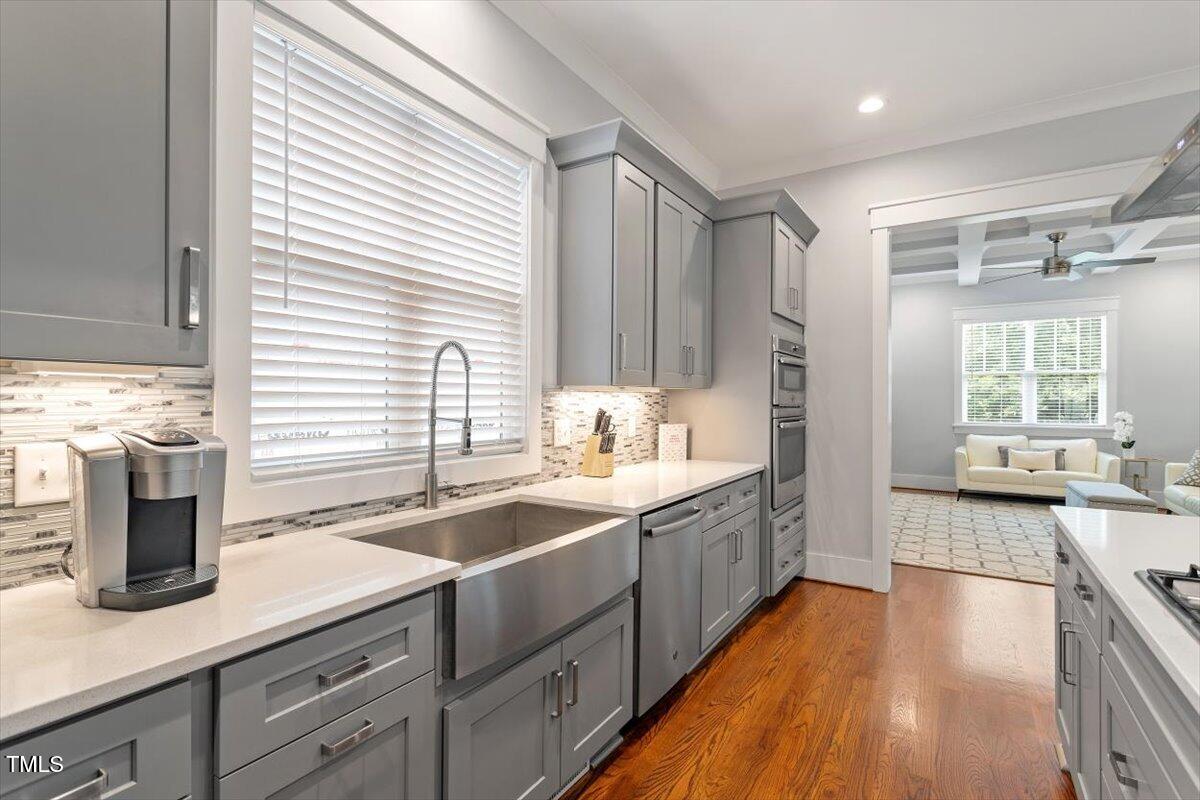 1215 Brookside Drive Raleigh, NC 27604 - Photo 12 of 34 a kitchen with stainless steel appliances granite countertop a sink and wooden cabinets