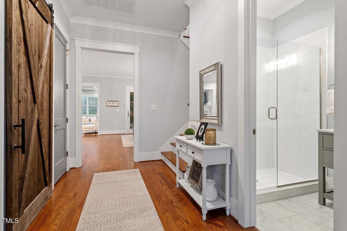 1215 Brookside Drive Raleigh, NC 27604 - Photo 16 of 34 a room with a bed and a mirror