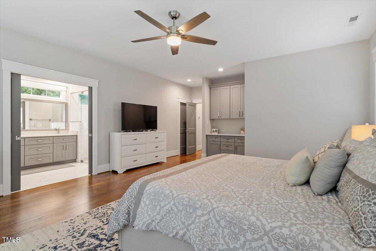 1215 Brookside Drive Raleigh, NC 27604 - Photo 20 of 34 a bedroom with a bed and a flat screen tv