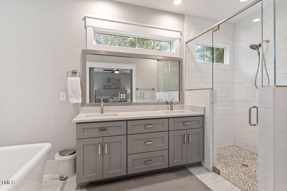 1215 Brookside Drive Raleigh, NC 27604 - Photo 23 of 34 a bathroom with a granite countertop sink a toilet and a mirror