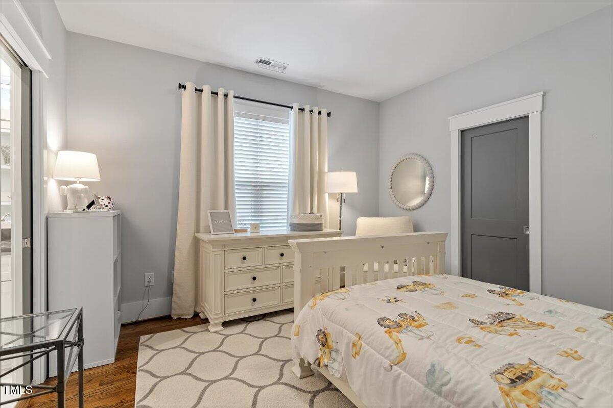 1215 Brookside Drive Raleigh, NC 27604 - Photo 27 of 34 a bedroom with a bed and a window