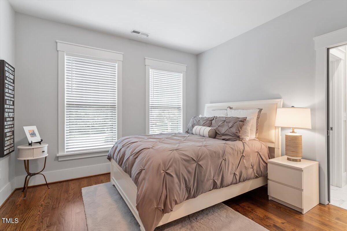 1215 Brookside Drive Raleigh, NC 27604 - Photo 29 of 34 a bedroom with a bed a lamp and a large window