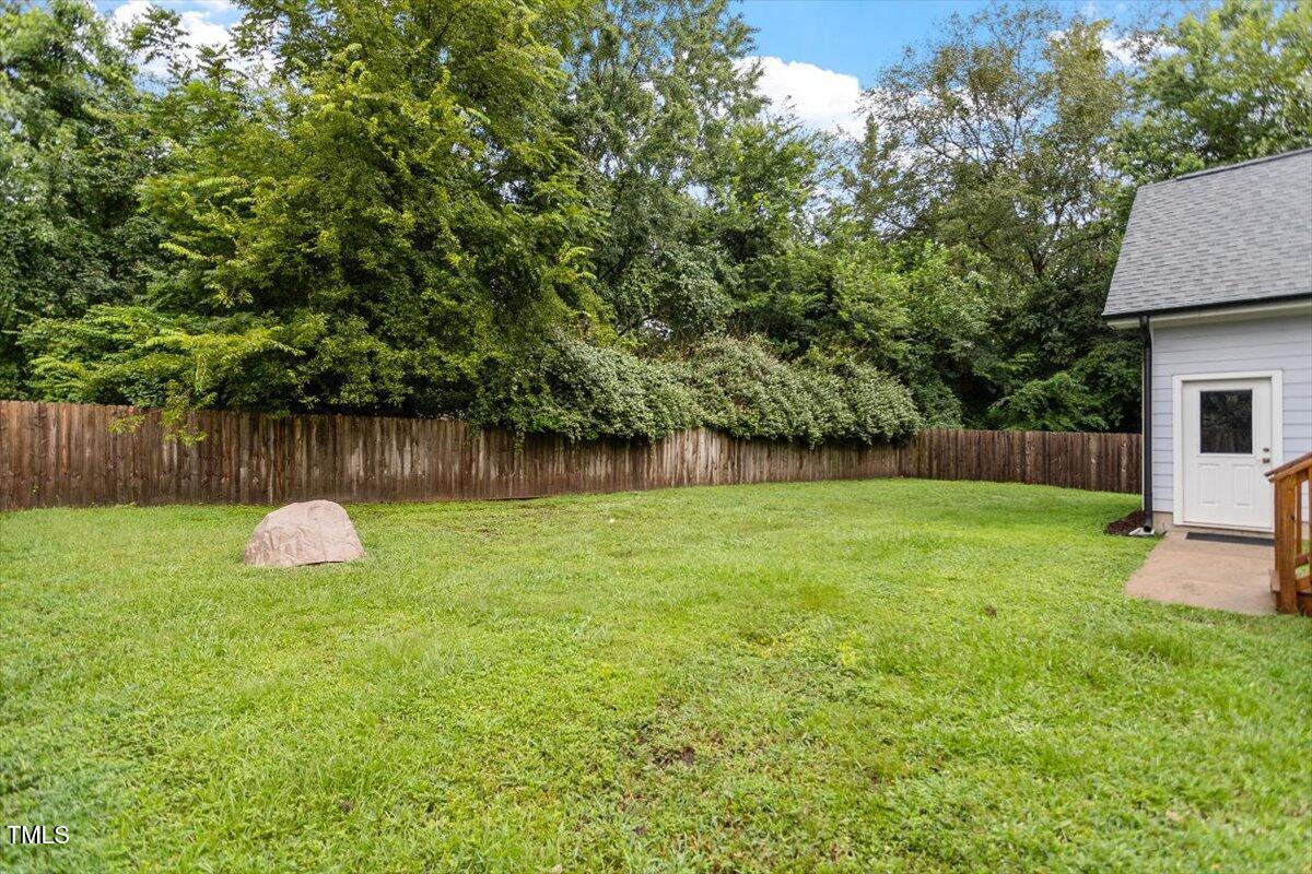 1215 Brookside Drive Raleigh, NC 27604 - Photo 34 of 34 a backyard of a house with lots of green space