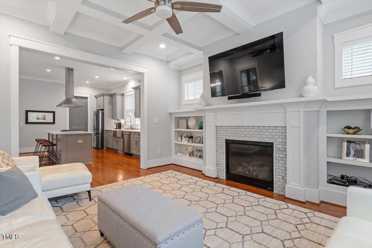 1215 Brookside Drive Raleigh, NC 27604 - Photo 8 of 34 a living room with furniture a flat screen tv and a fireplace