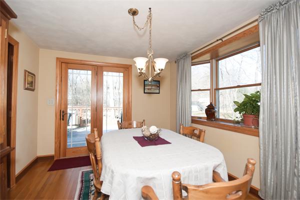 8 Michael Road Billerica, MA 01862 - Photo 4 of 10 a dining room with wooden floor a chandelier a wooden table and chairs