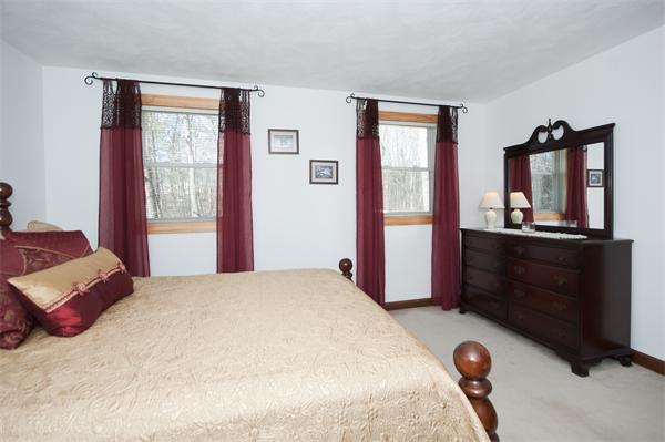 8 Michael Road Billerica, MA 01862 - Photo 8 of 10 a bedroom with a bed and a dresser