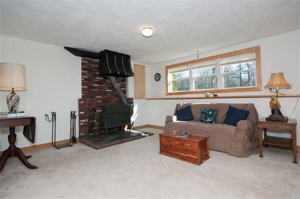 8 Michael Road Billerica, MA 01862 - Photo 9 of 10 a living room with furniture and a fireplace
