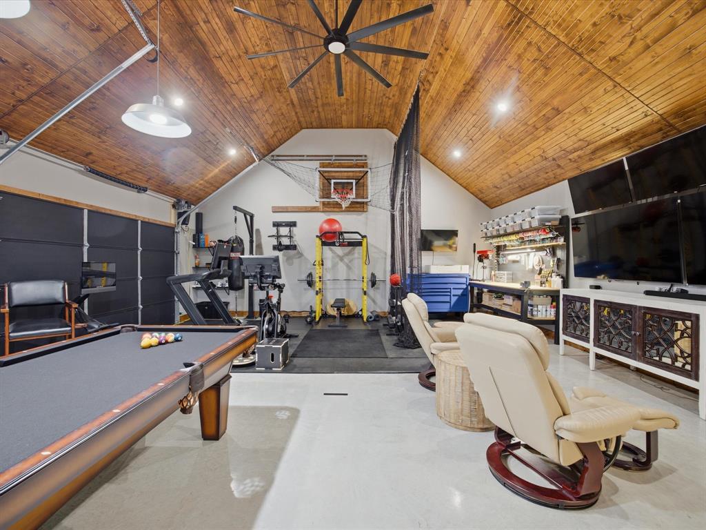 117 Ranchview Court Bowie, TX 76230 - Photo 29 of 40 a room with gym equipment and a flat screen tv