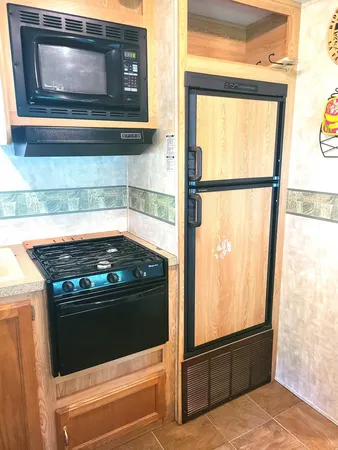 a kitchen with a sink stove and refrigerator