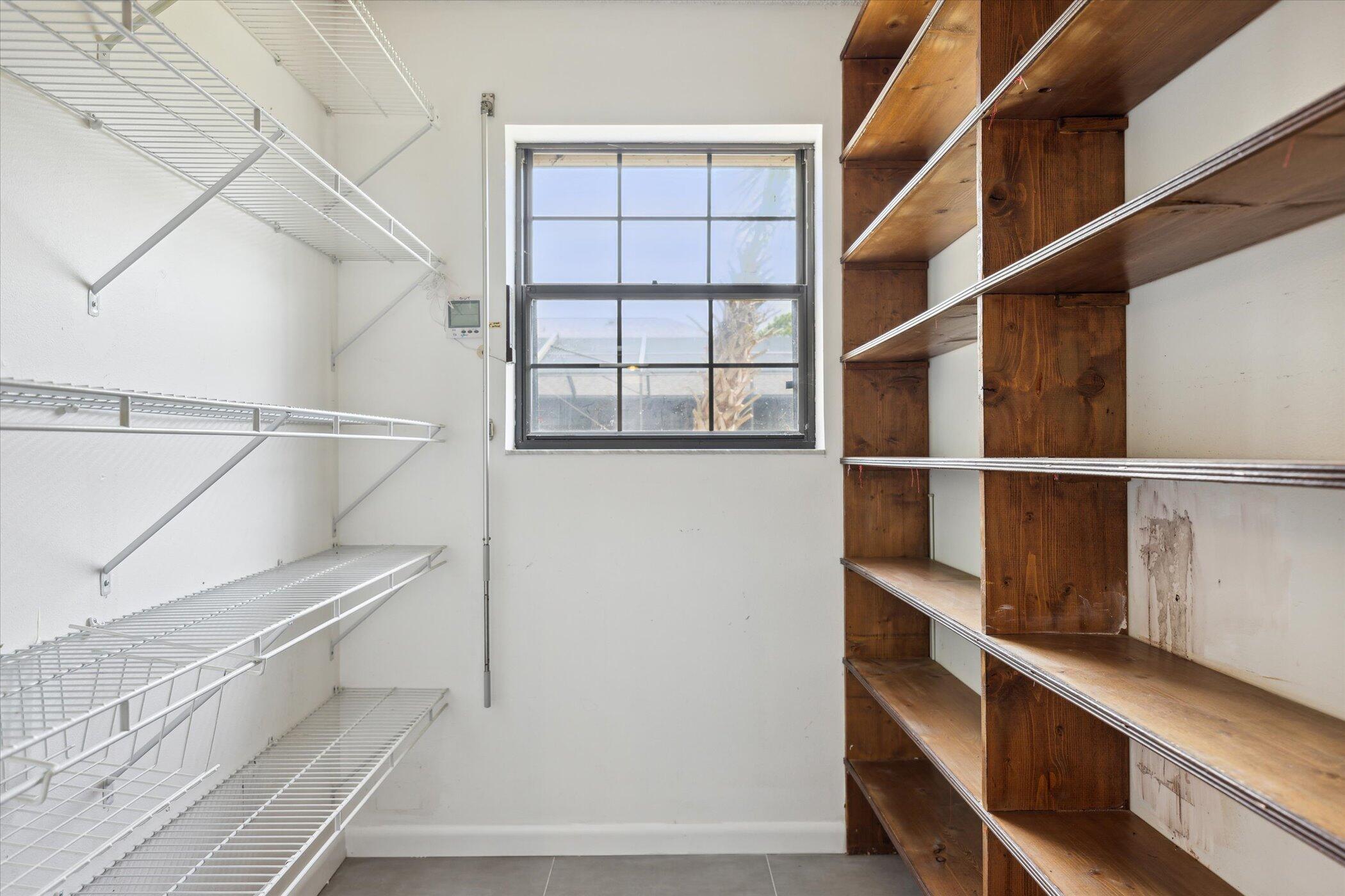 1045 Garden Road Merritt Island, FL 32952 - Photo 11 of 37 a view of walk in closet with empty racks