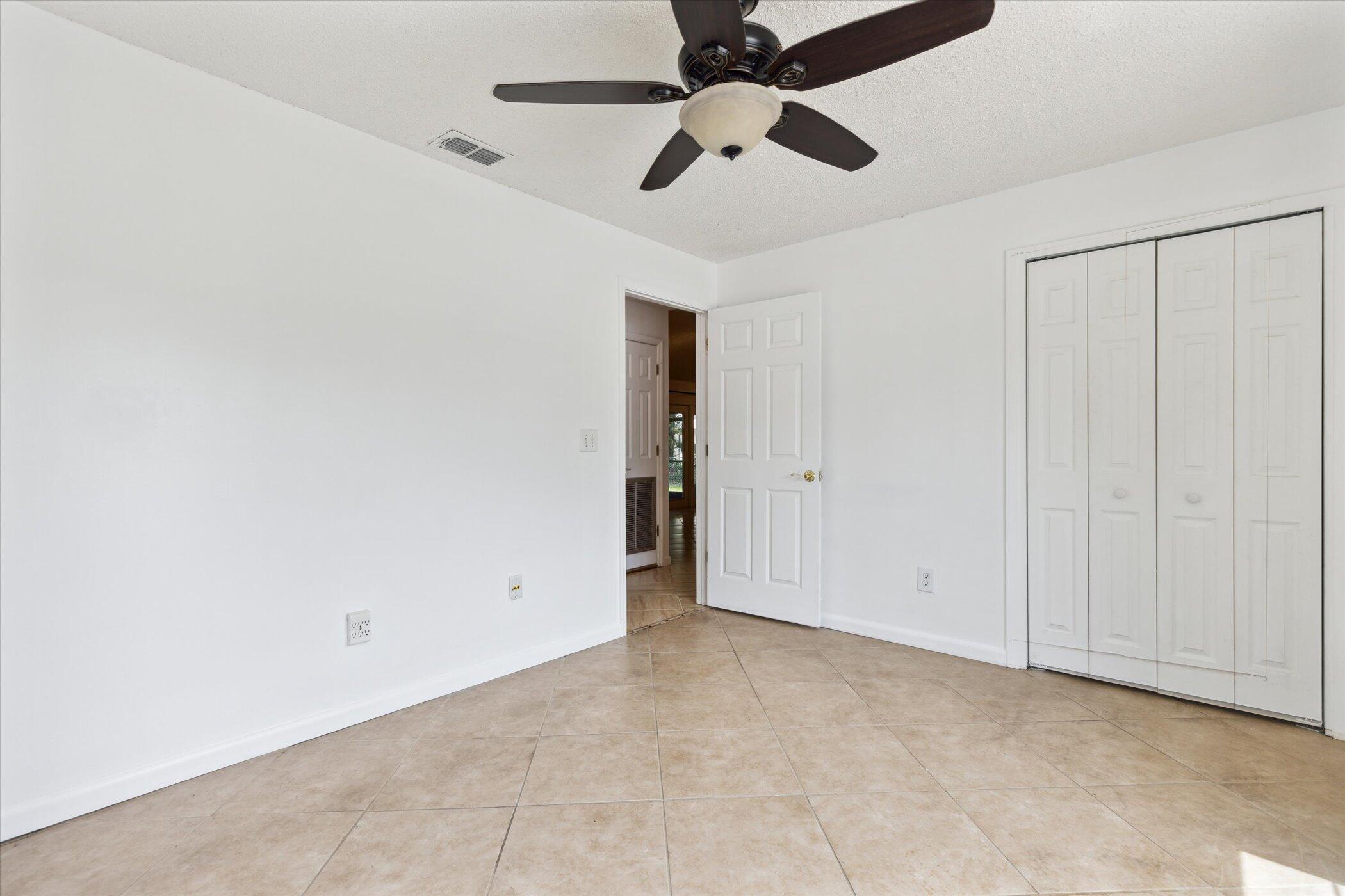 1045 Garden Road Merritt Island, FL 32952 - Photo 25 of 37 an empty room with chandelier fan