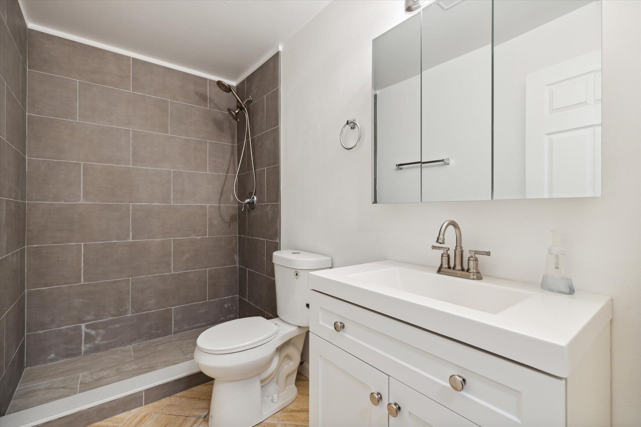 1045 Garden Road Merritt Island, FL 32952 - Photo 26 of 37 a bathroom with a sink toilet and shower