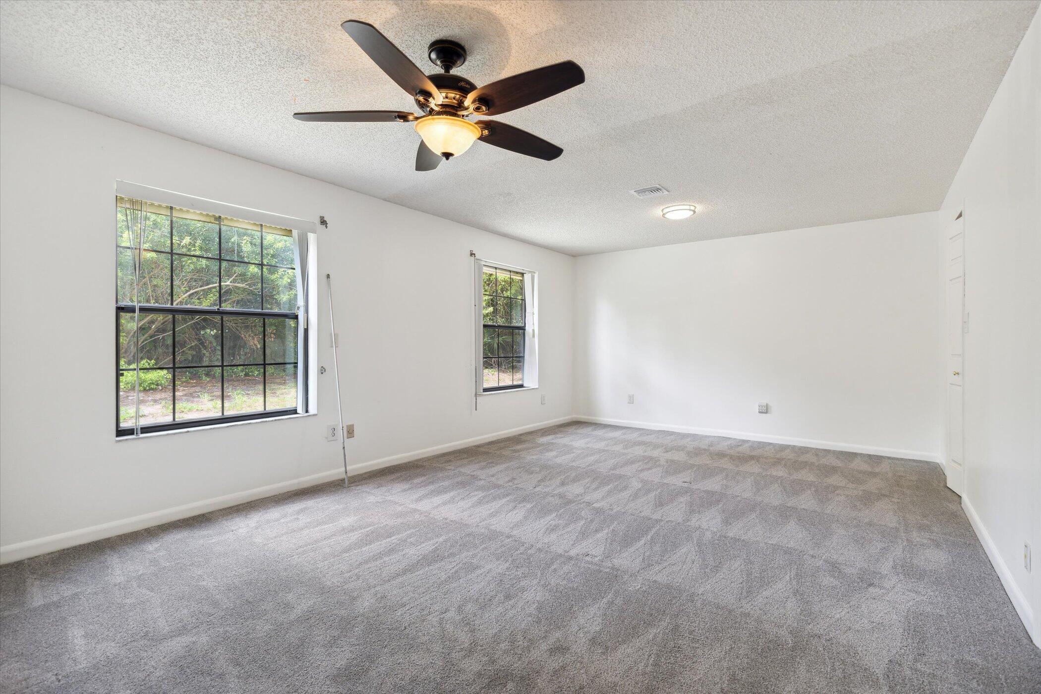 1045 Garden Road Merritt Island, FL 32952 - Photo 27 of 37 an empty room with a window and a fan
