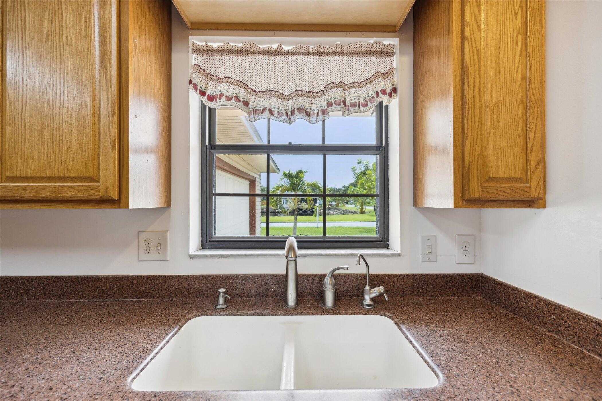 1045 Garden Road Merritt Island, FL 32952 - Photo 8 of 37 a kitchen with a sink and a window